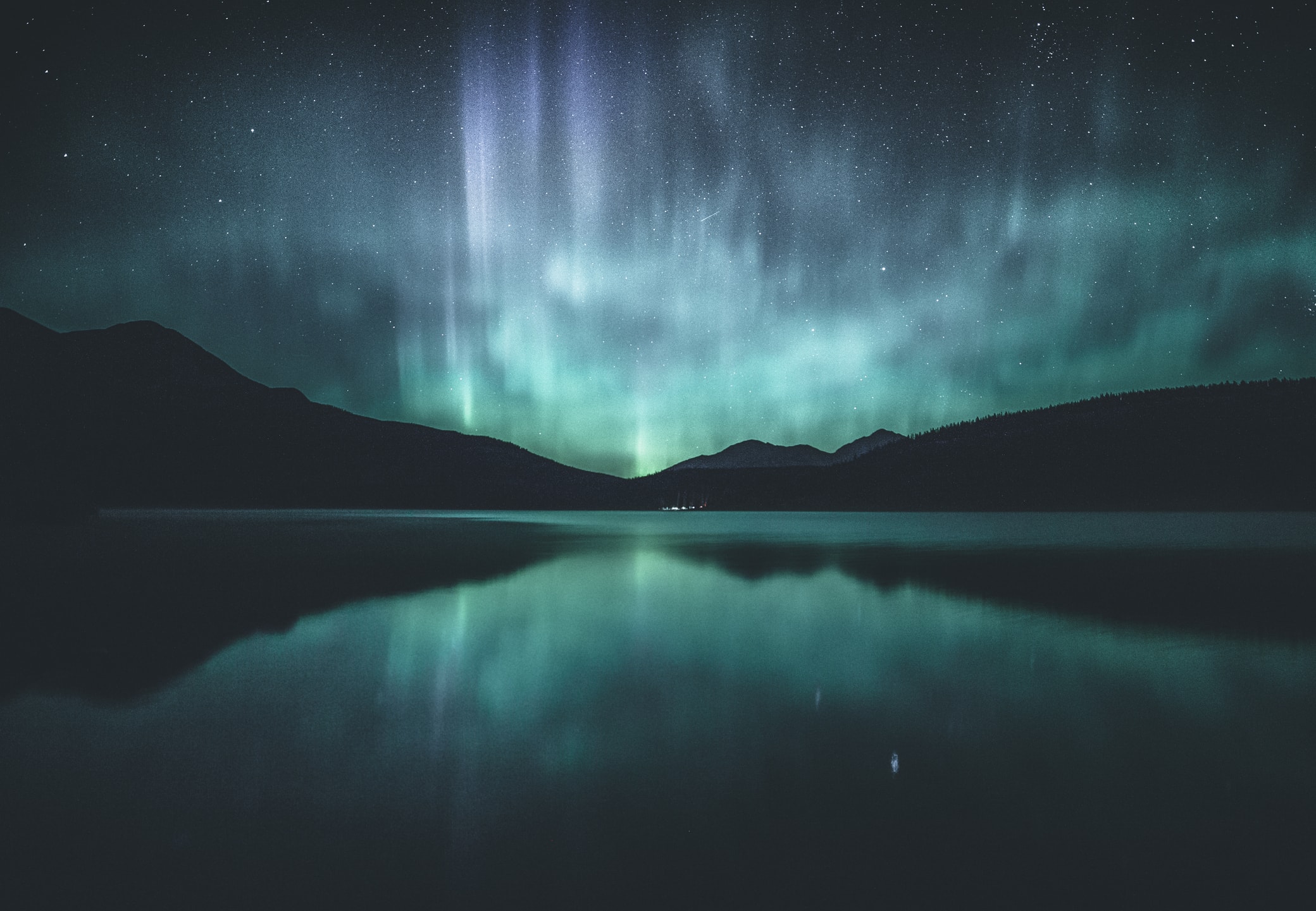 The Northern lights shine in the night sky above a lake in Jasper, Alberta.