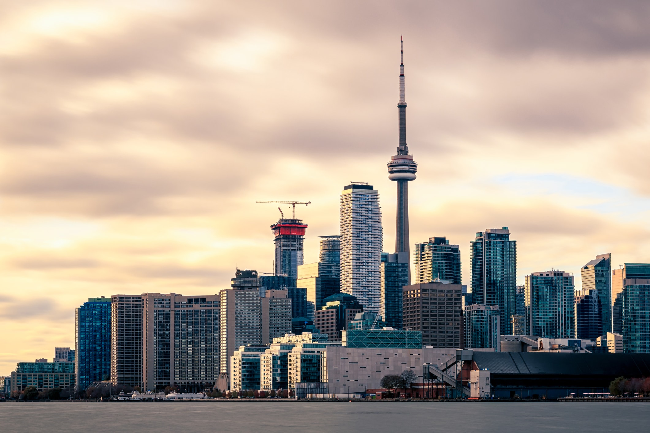 The Toronto skyline at sunset, including the CN Tower.