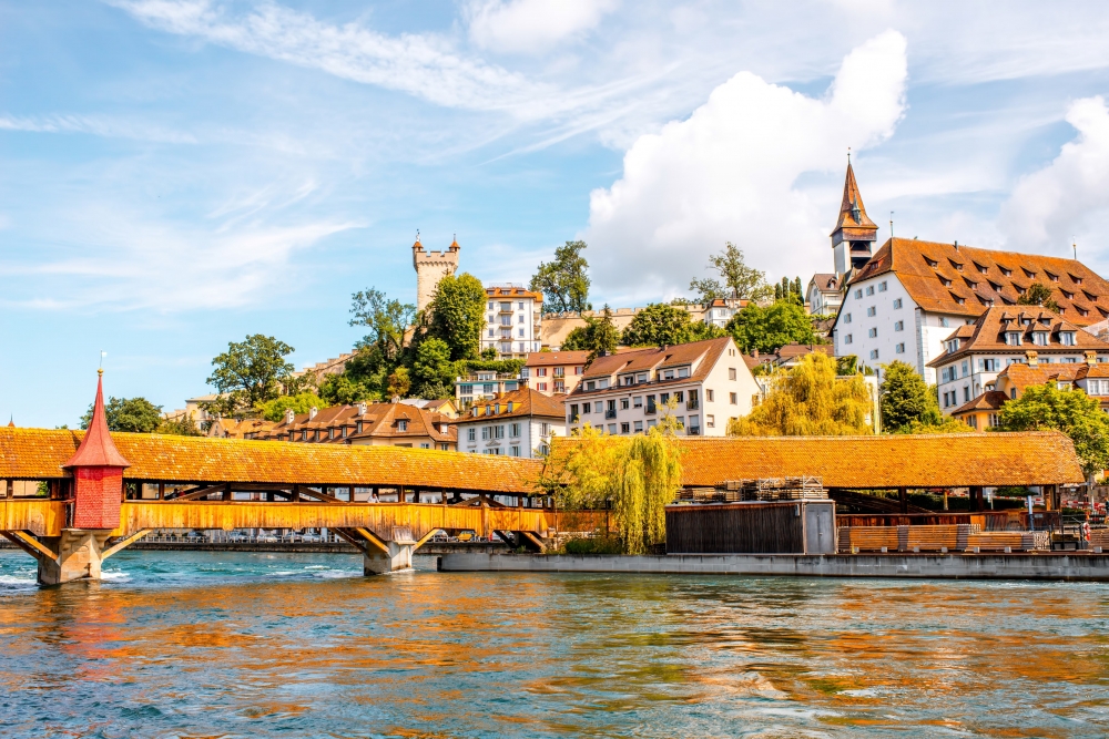 Spruer Bridge with whitewashed buildings in the background in Lucerne, Switzerland